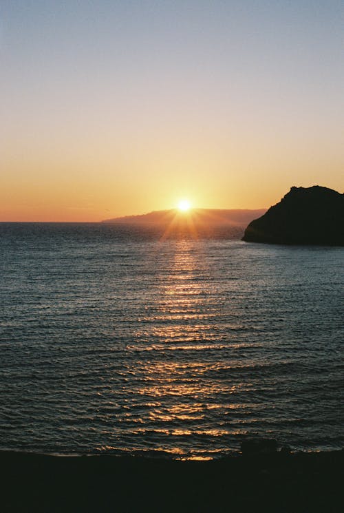 Free Beautiful Scenery of Placid Sea during Sunset Stock Photo