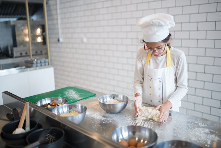 A Young Chef Kneading A Dough