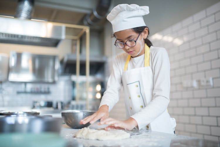 A Young Chef Kneading A Dough