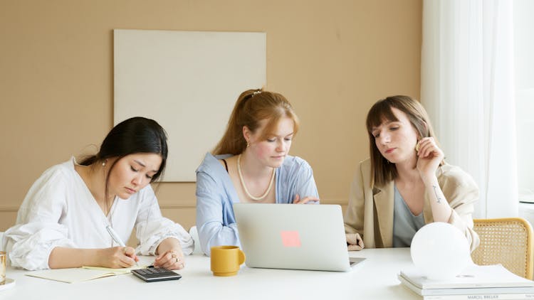 Three Women Working In The Office