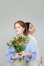 Woman in Blue Dress Shirt Holding White Flower Bouquet