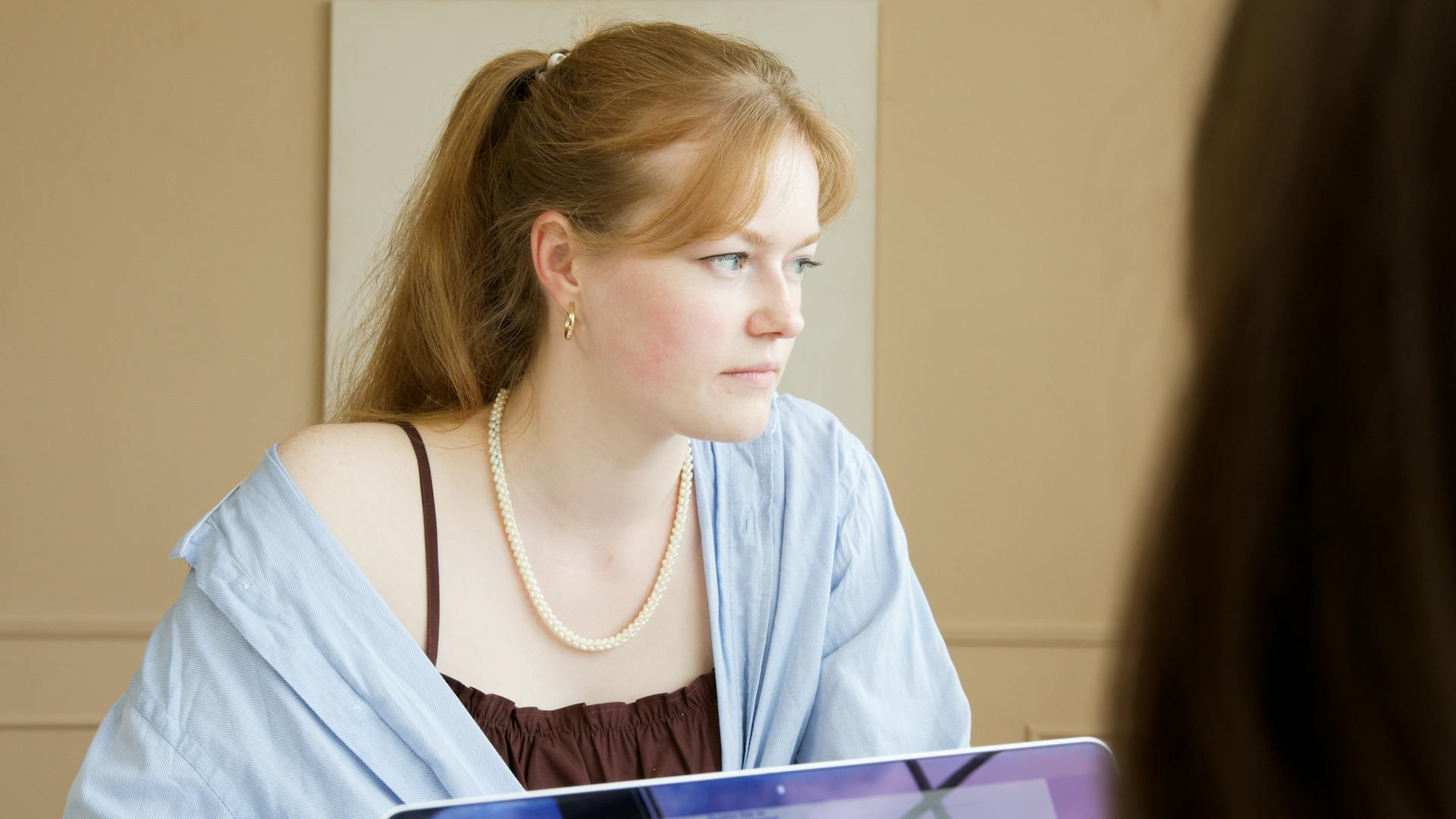 Woman in Blue Cardigan Looking Afar