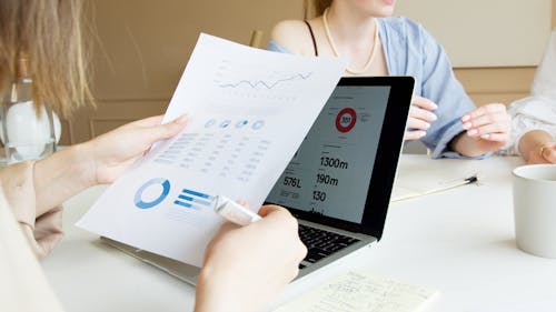 Close-up Shot of a Person Holding Printed Papers 