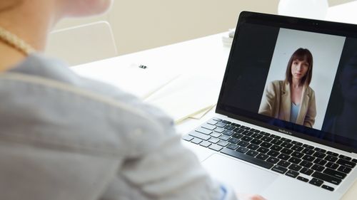 Teammate on a video call at a desk — photo by Artem Podrez on Pexels