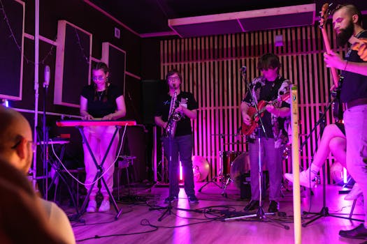 Energetic live band performing indoors with vibrant lighting in a small club setting.