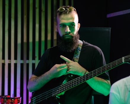 Portrait of a bearded bassist rehearsing in a music studio.