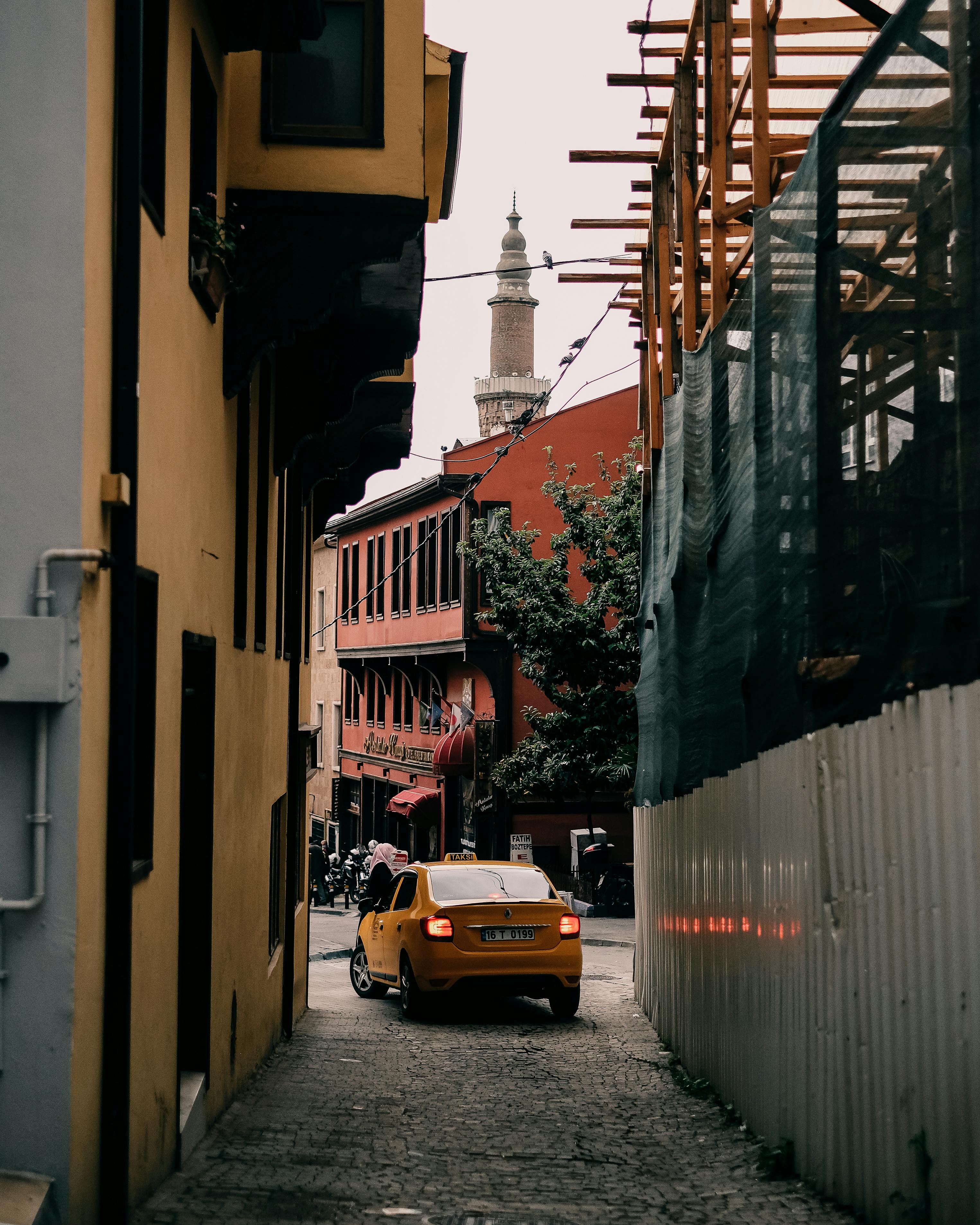 car driving out of narrow city street