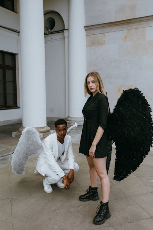 A Man and Woman Wearing Angel Costumes