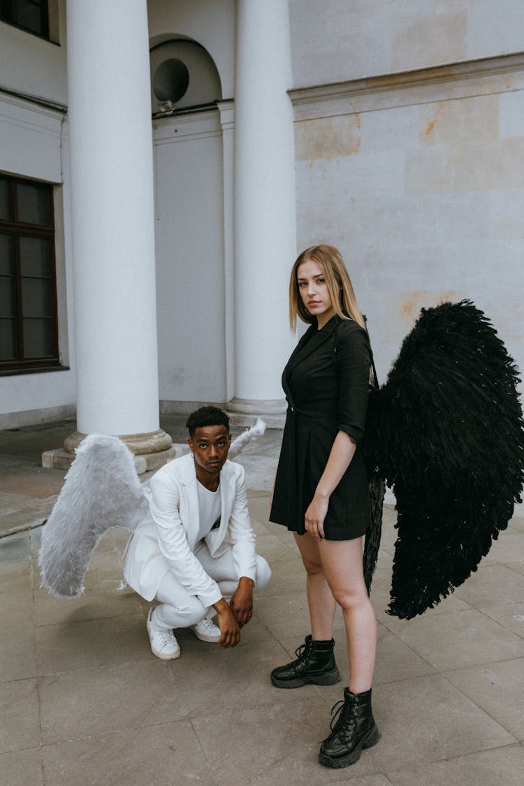 A Man And Woman Wearing Angel Costumes