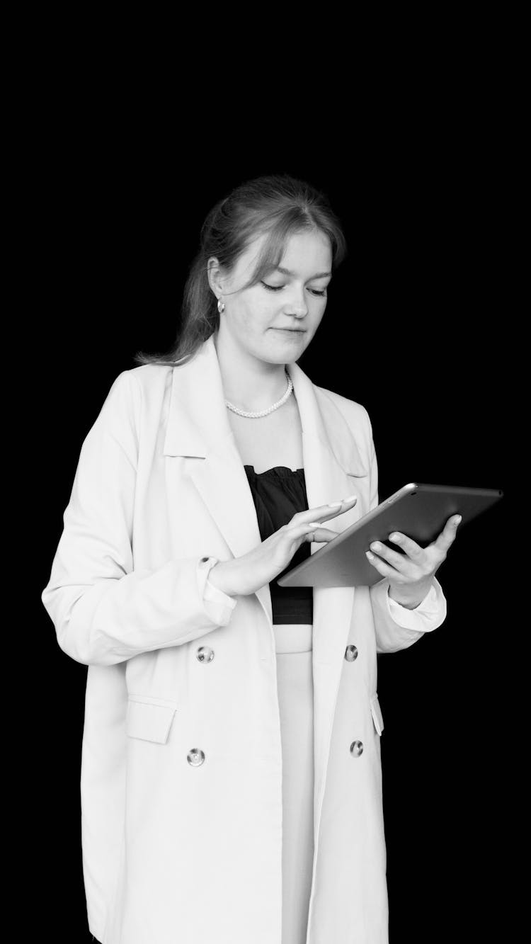 Black And White Photo Of Woman Holding A Tablet