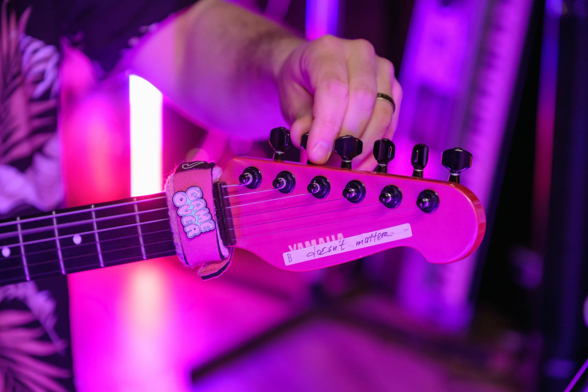 A Person Tuning an Electric Guitar