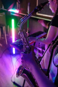 Musicians practicing with saxophone and keyboard in a colorful studio setting.