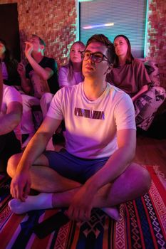 A Man Sitting on the Floor While Watching 