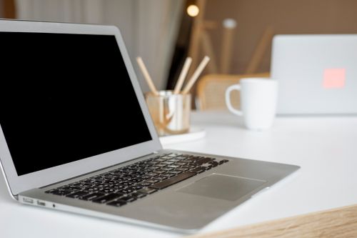 Free A sleek laptop on a modern office desk, ideal for remote work or business environments. Stock Photo
