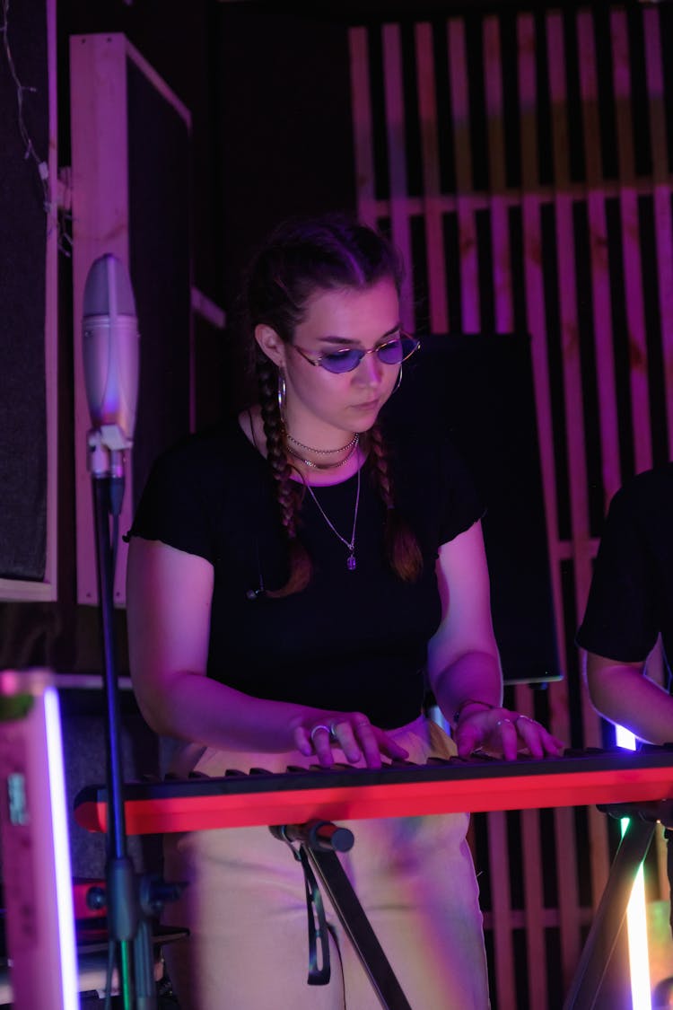 A Woman Playing The  Keyboard 