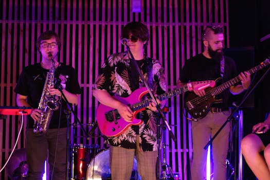 Energetic live performance by a band with electric guitar, saxophone, and bass.