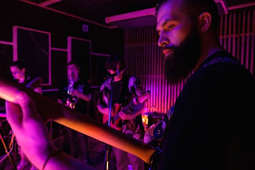 A band practicing in a music studio with vibrant lighting and various instruments.