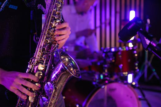 Musicians playing saxophone and drums during a vibrant live performance.