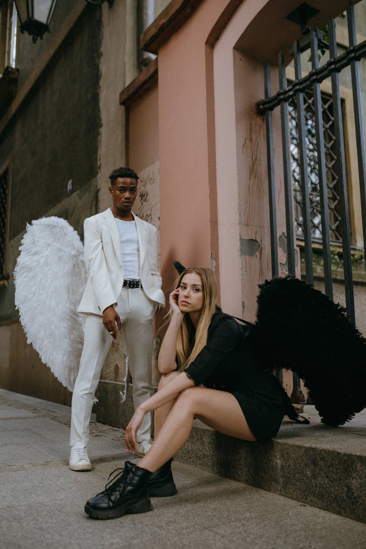 A Man And Woman Wearing Angel Costumes