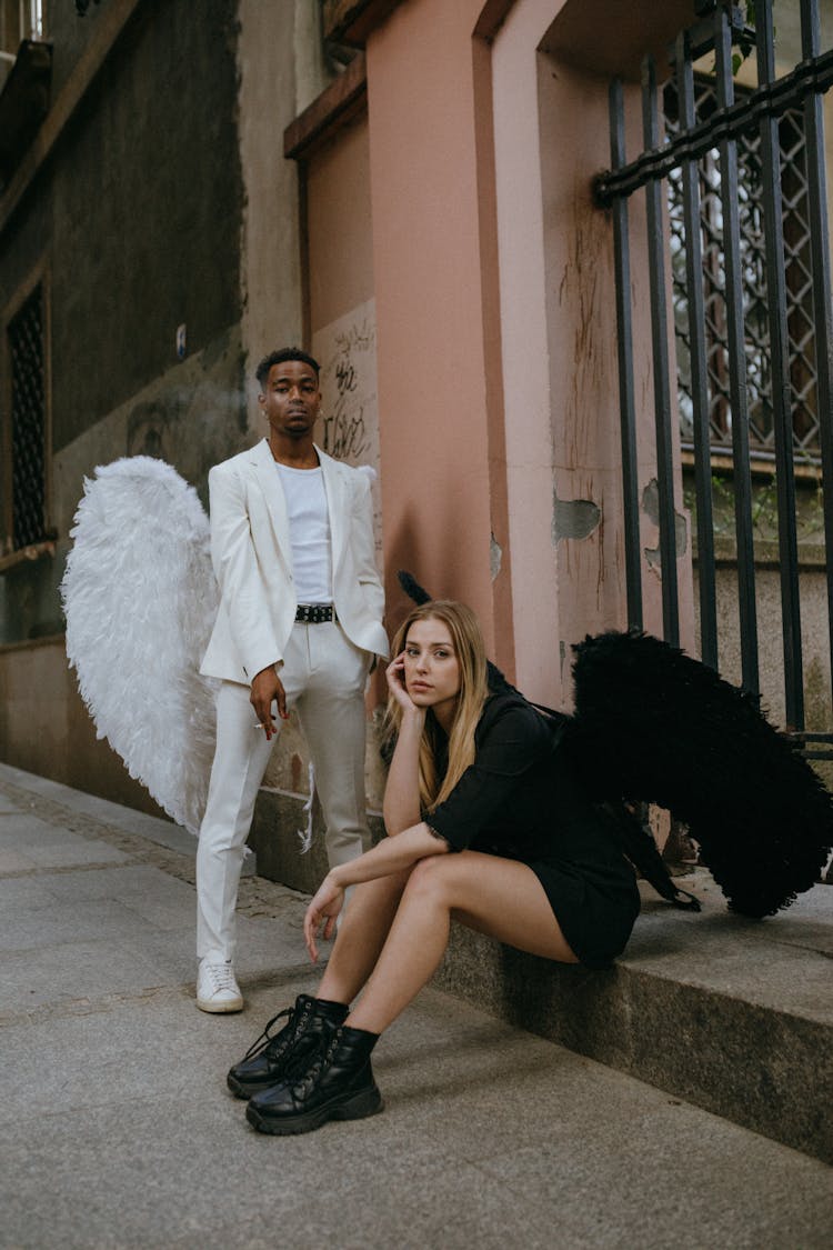 A Man And Woman Wearing Angel Costumes