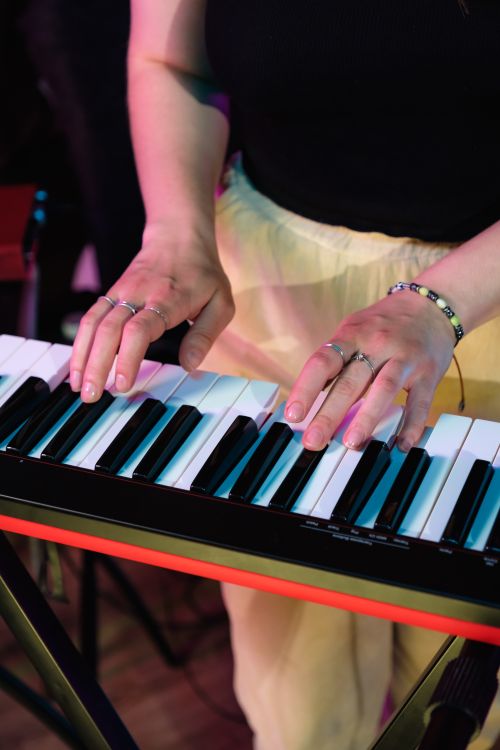 Free A person playing a keyboard with rings on fingers, creating music. Stock Photo
