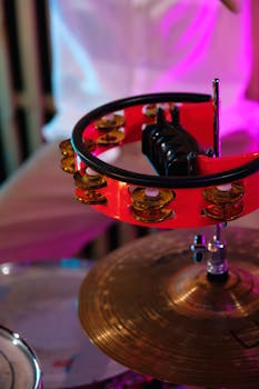 Vibrant close-up of a tambourine and cymbals at a live music event.
