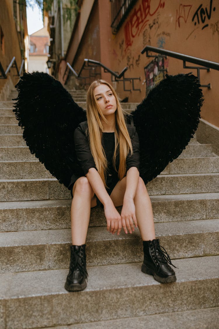 An Angel Sitting On A Staircase