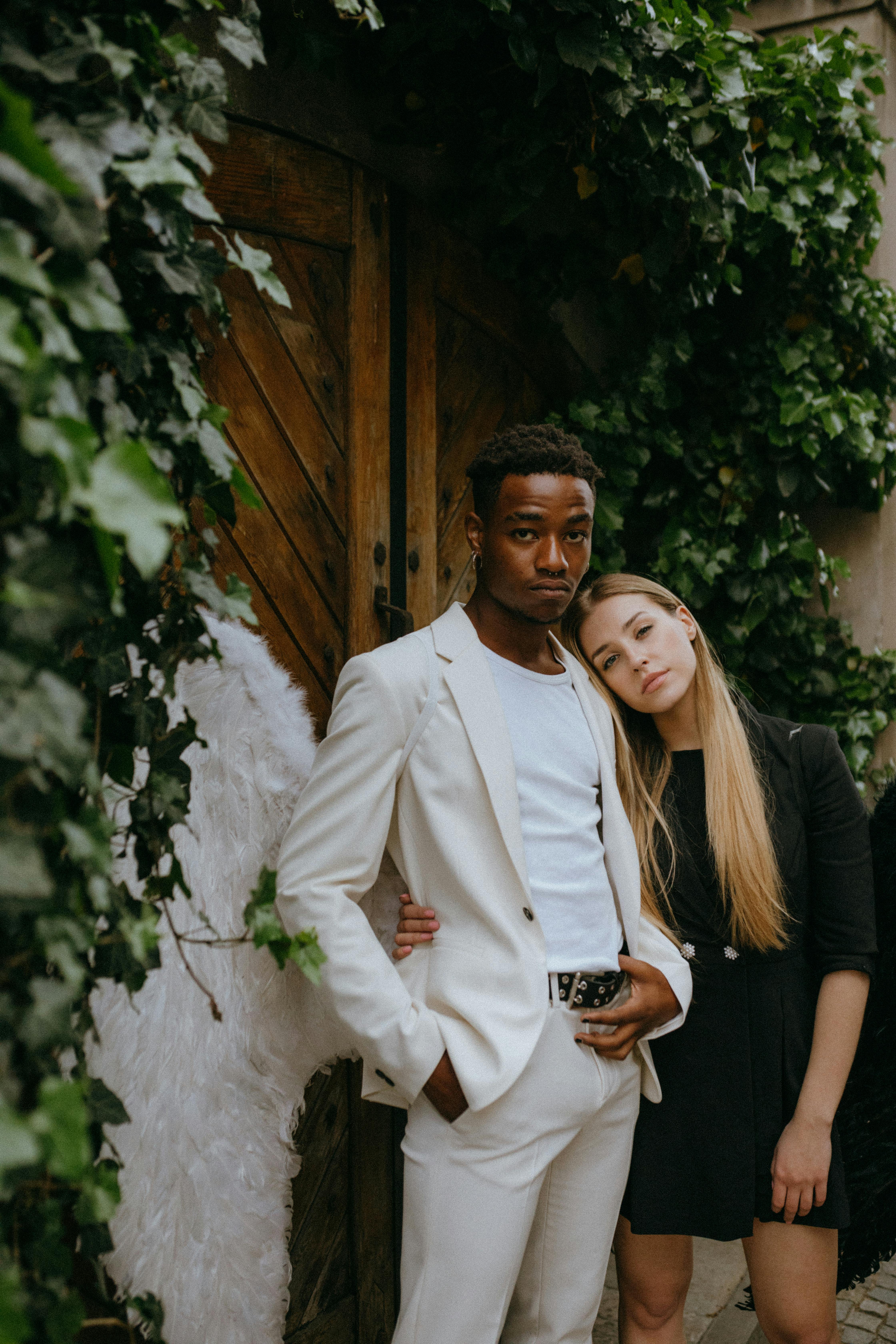 a man and woman wearing angel costumes