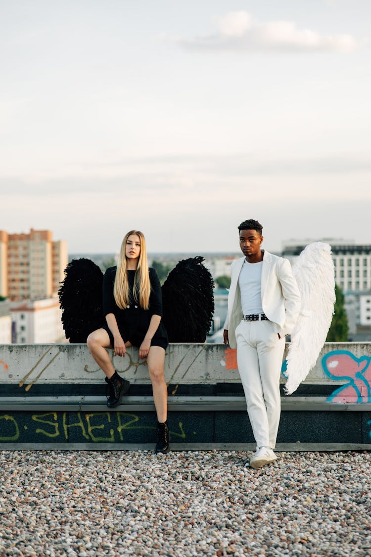 A Man And Woman Wearing Angel Costumes