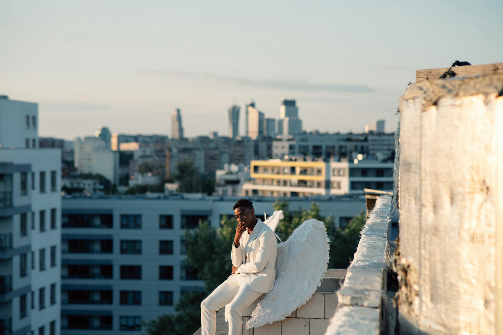 An Angel Sitting on the Edge of a Concrete