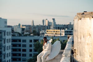 An Angel Sitting on the Edge of a Concrete