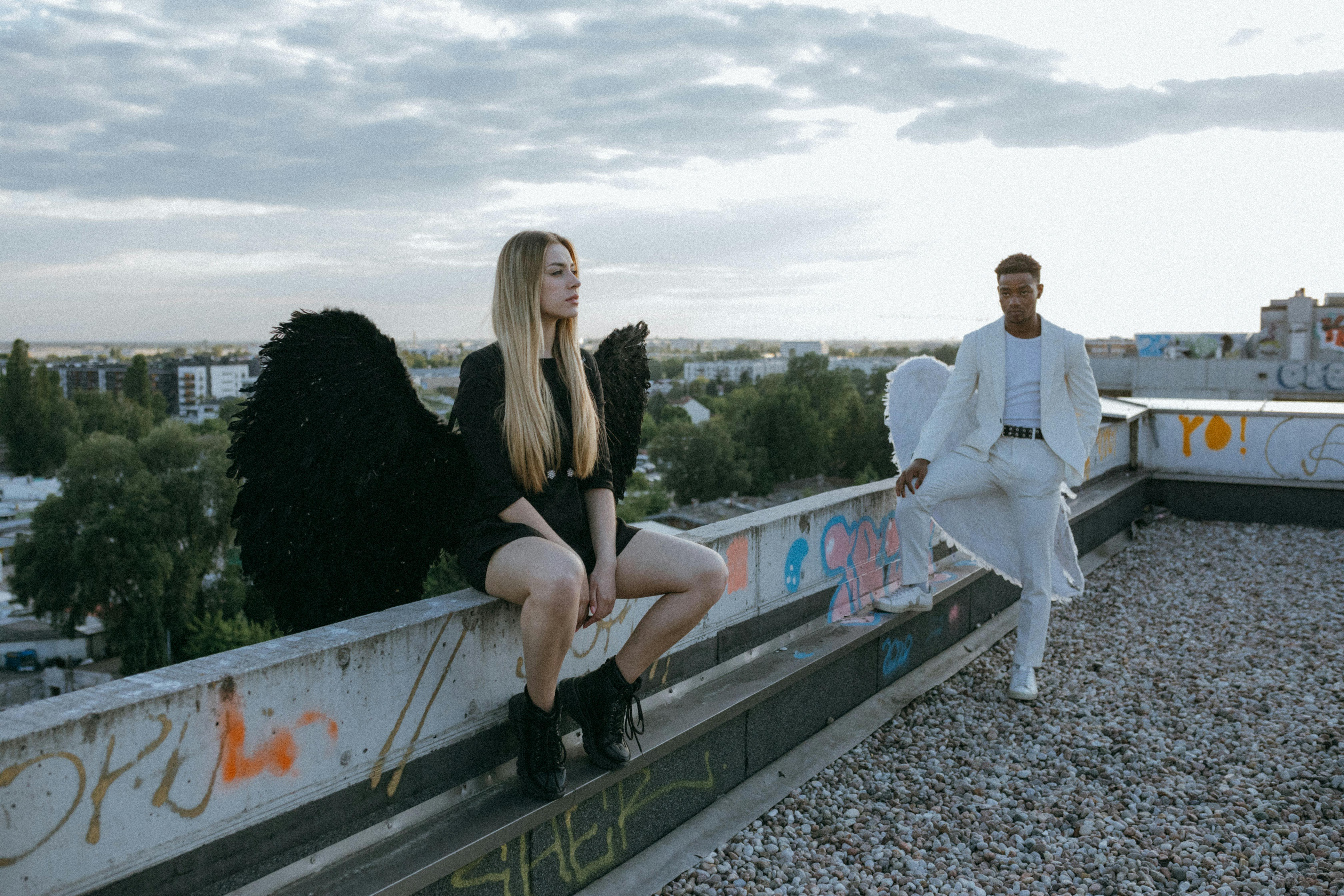 a man and woman wearing angel costumes