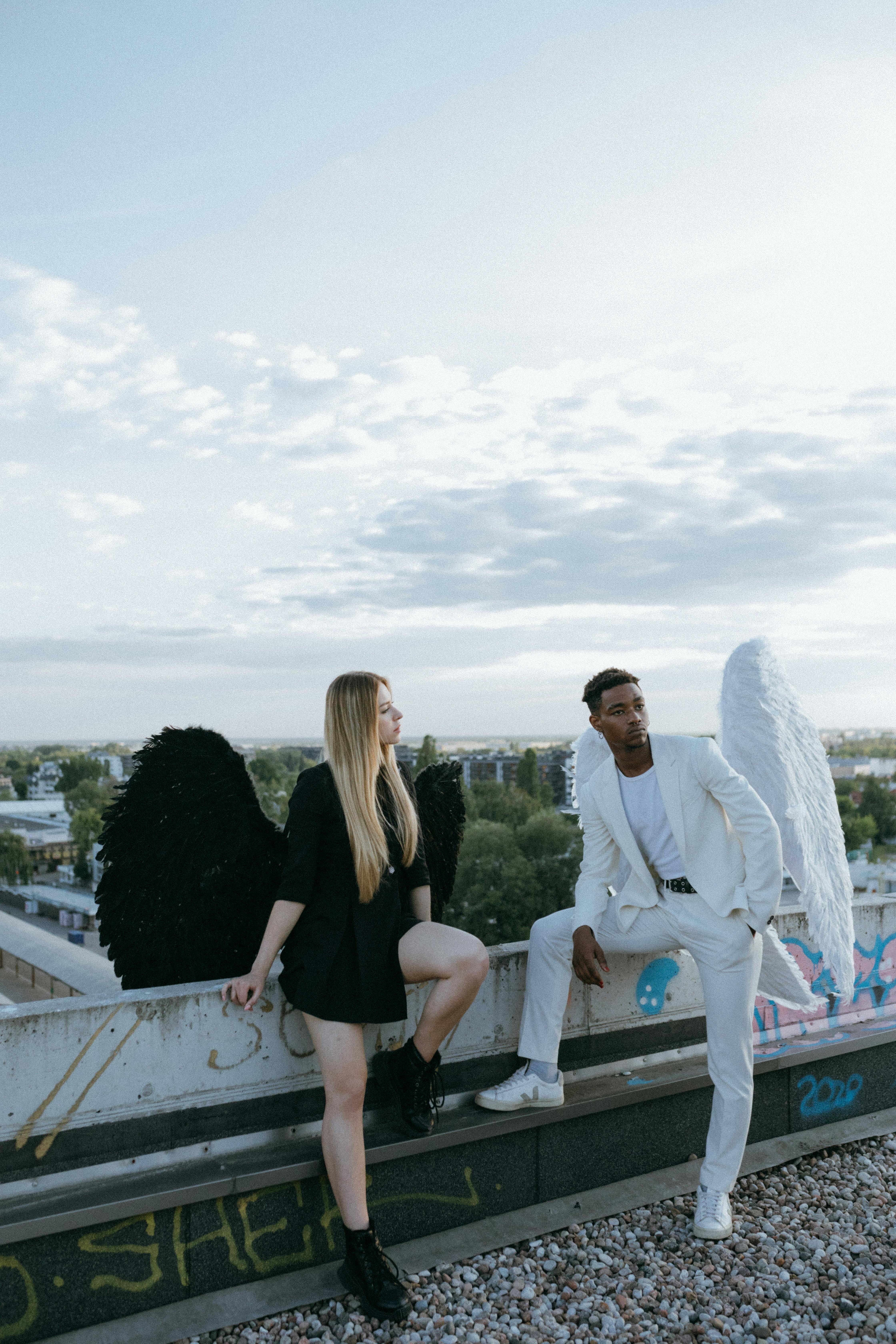 a man and woman wearing angel costumes