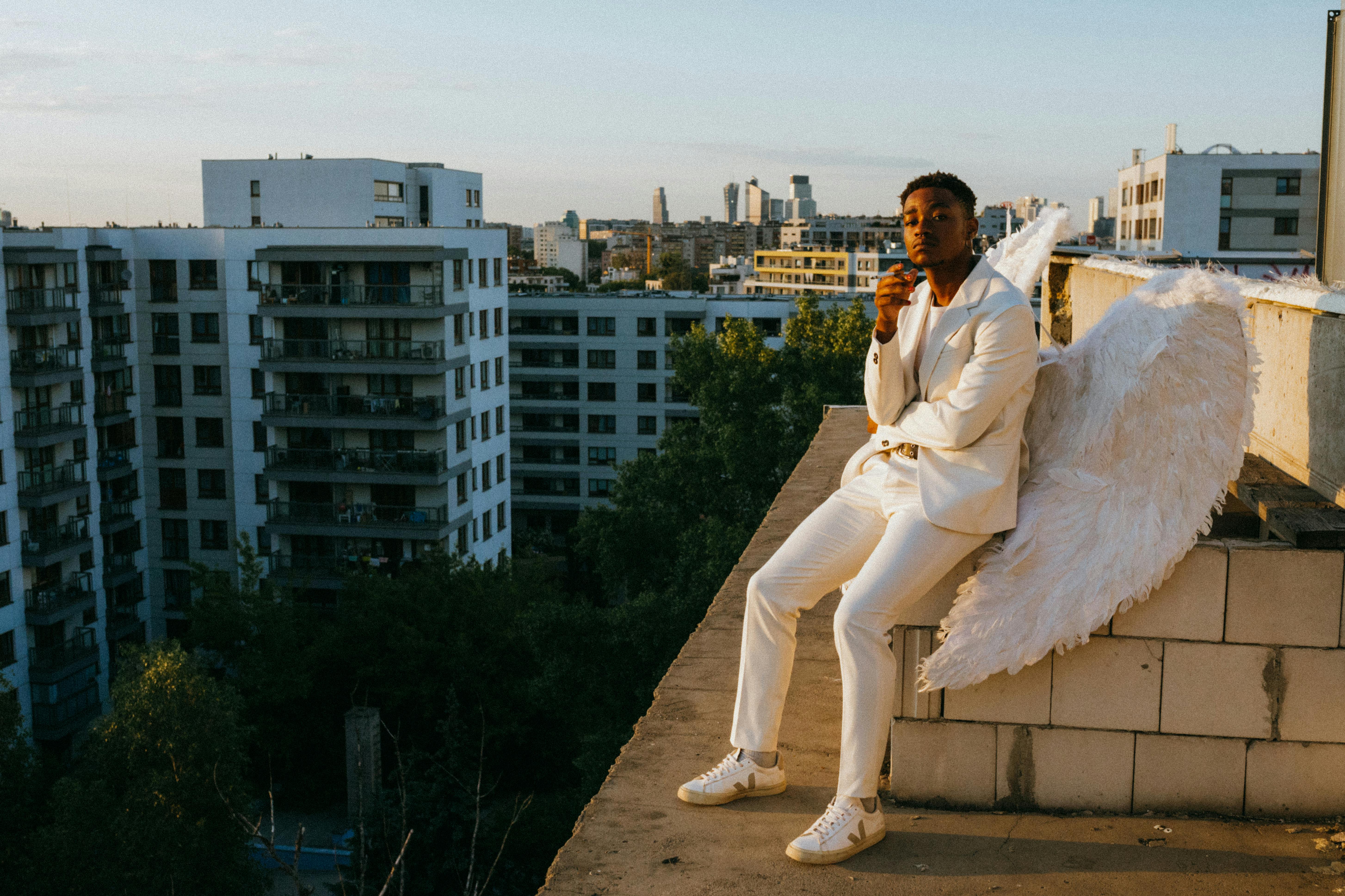 an angel sitting on the edge of a concrete