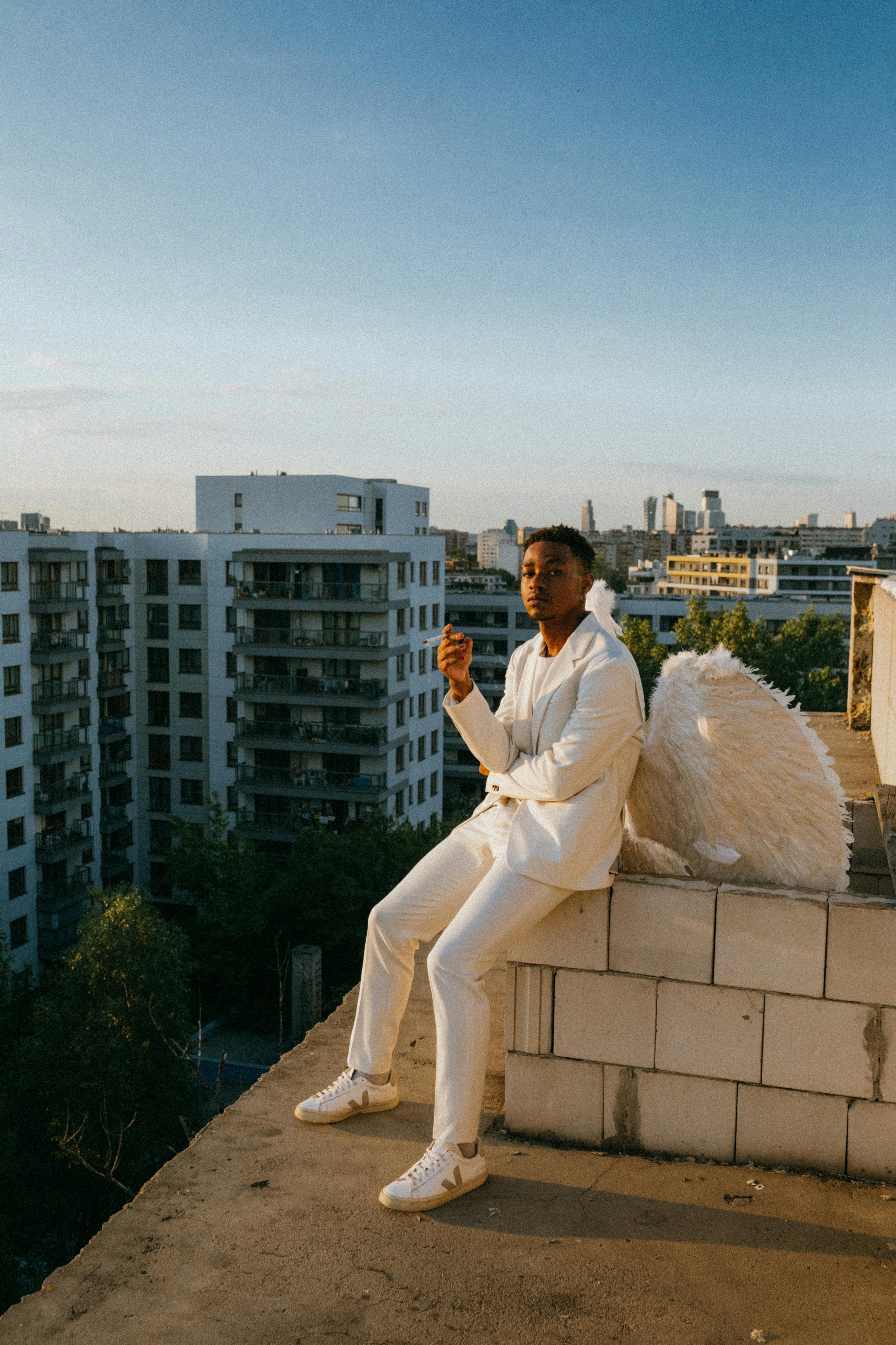 an angel sitting on the edge of a concrete