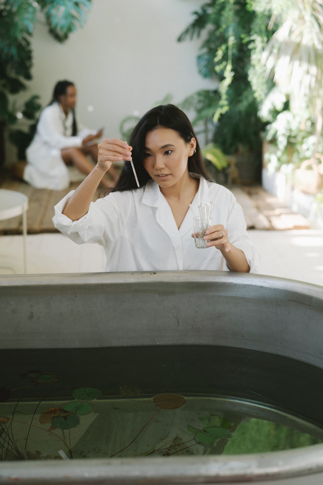 Scientist examining water samples in a lab, representing the precision of testing pH and EC in hydroponic nutrient solutions
