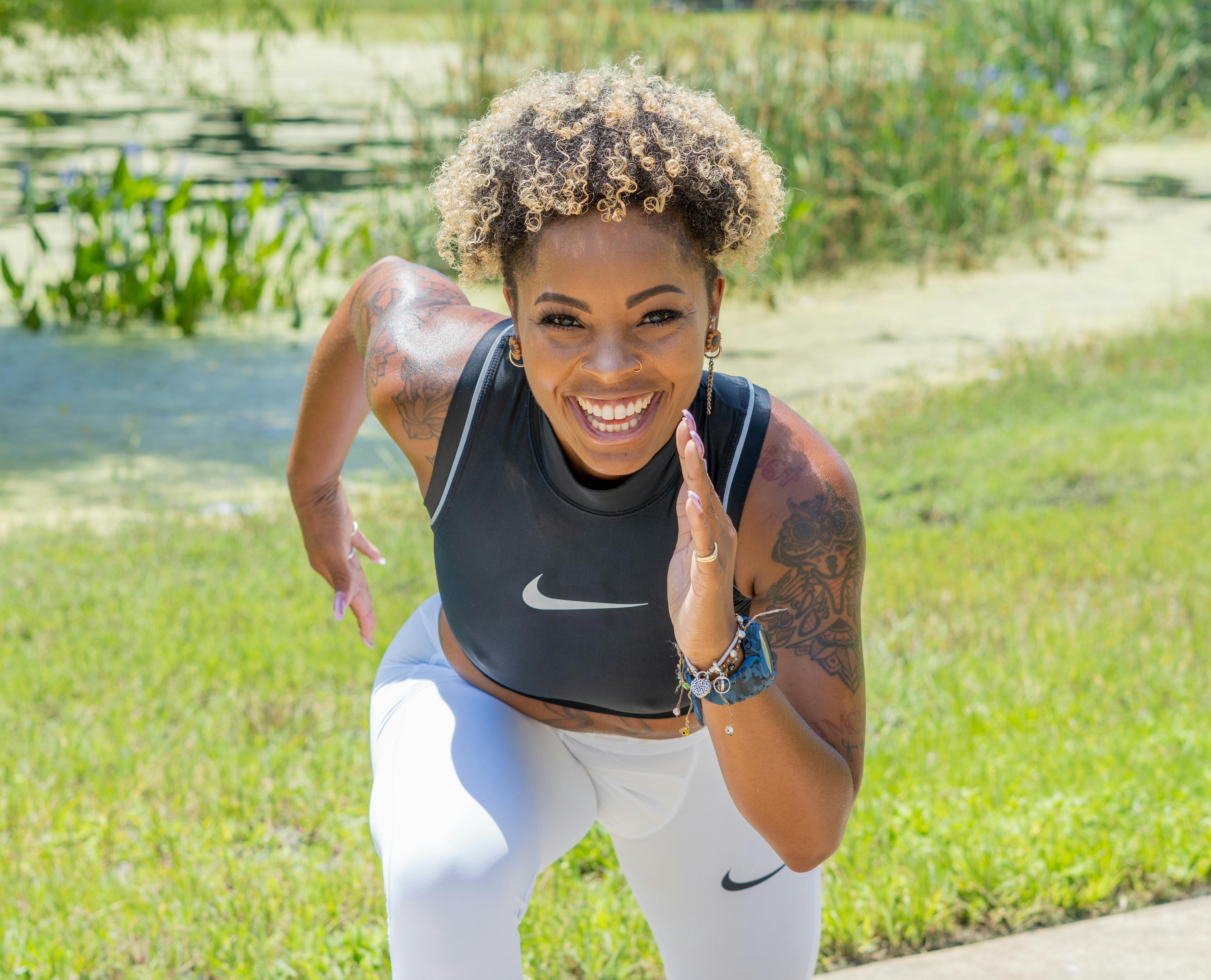 photo of a woman with curly hair doing a running pose