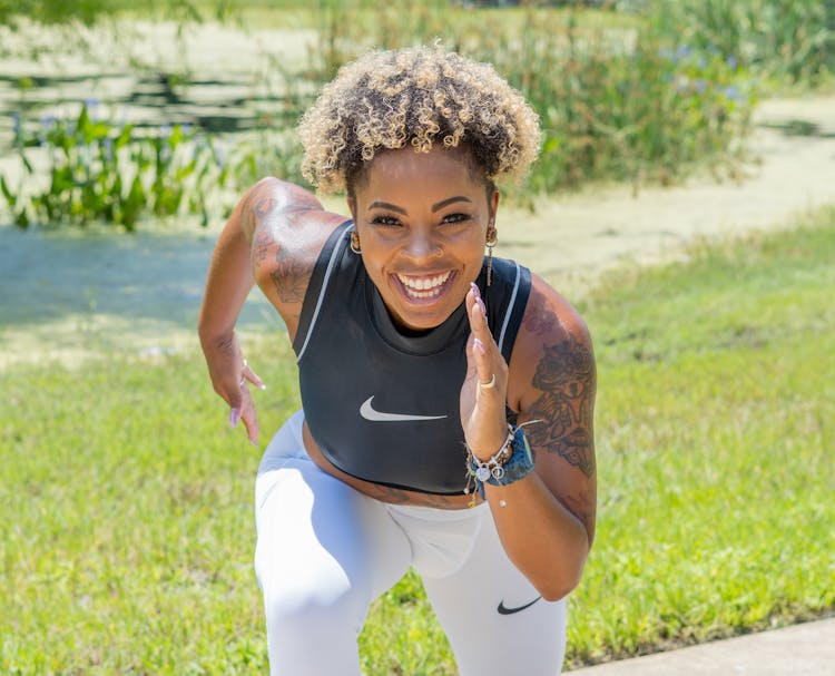 Photo Of A Woman With Curly Hair Doing A Running Pose