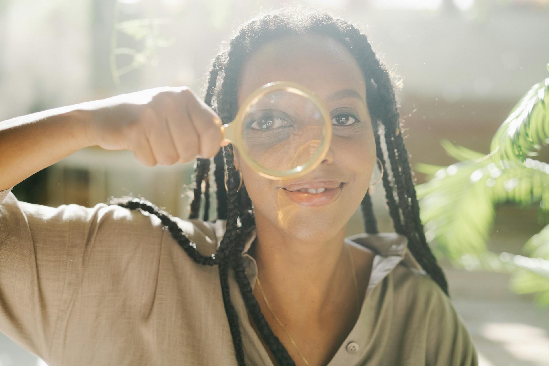 A Woman Holding a Magnifying Glass