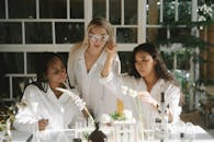 Woman in White Dress Shirt Smiling Beside Woman in White Dress Shirt