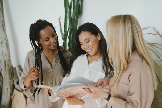 2 Women in White Dress Shirt Holding White Printer Paper