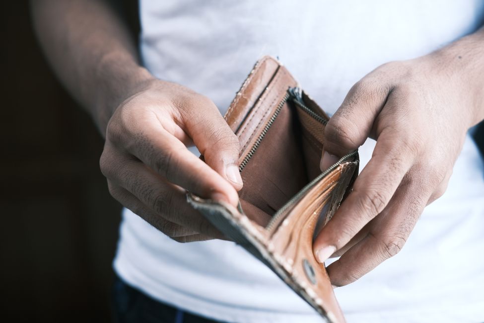 person holding empty wallet