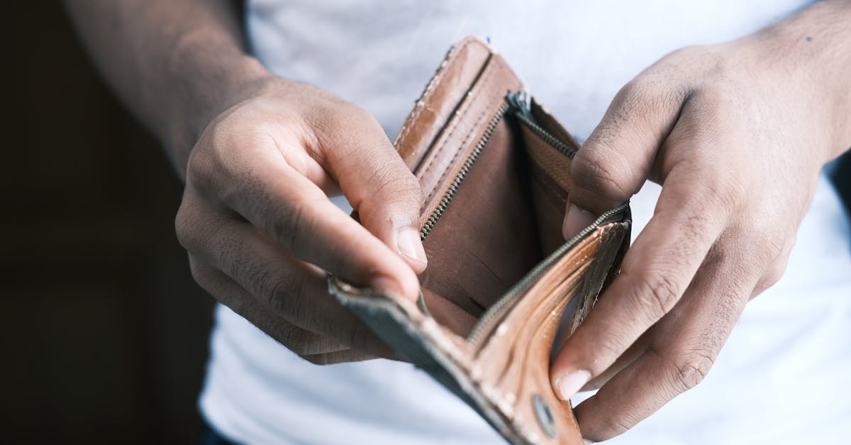 Photo by Towfiqu barbhuiya Close-up of hands holding an empty wallet, highlighting financial struggles and economic crisis.