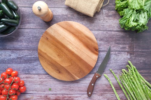 Wooden Chopping Board and Knife With Fresh Vegetables 