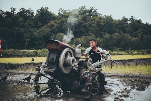Kid Using a Machine in the Farm