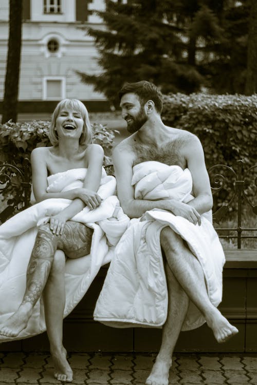 Man and Woman Covering Their Bodies with Comforter
