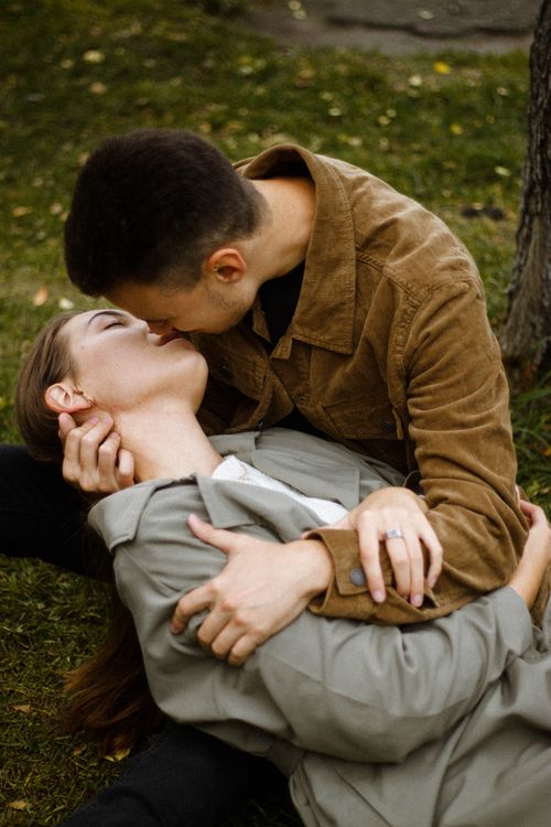 Free Couple sharing a tender, emotional moment outdoors in a serene park Stock Photo
