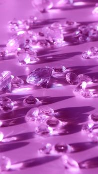 Elegant display of sparkling purple gemstones casting shadows on a reflective surface.