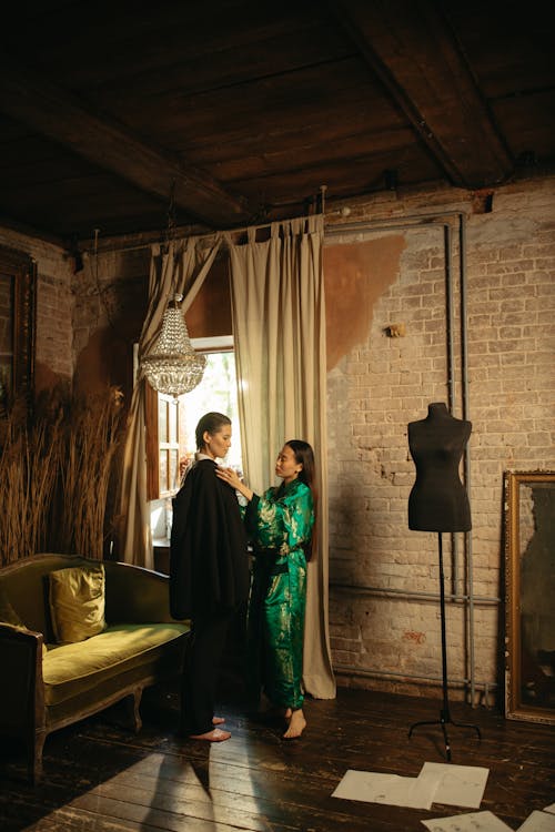 Woman in a Kimono Dressing a Woman in a Suit 