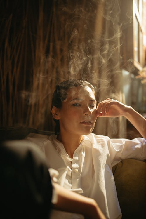Close-Up Shot of Woman in White Shirt Smoking